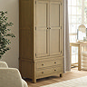 image of solid oak wardrobe with 2 doors and 2 drawers, stood tall in bedroom on wooden flooring