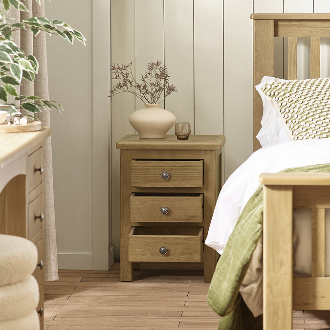 image of solid oak bedside table with three drawers open to suggest space within
