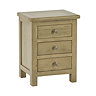 image cut out on white background of solid wood three drawer bedside table