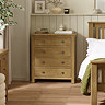 image of 4 drawer solid oak chest next to matching bed in modern country style bedroom