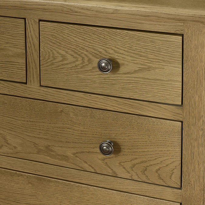 close up image of solid oak chest of drawers with round metal handles