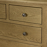 close up image of solid oak chest of drawers with round metal handles