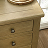 close up on oak drawers of solid dressing table with round metal handles