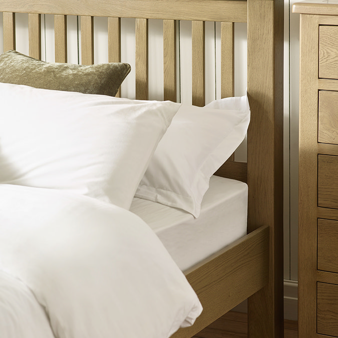 close up image of top half of solid oak bed with slatted bedframe