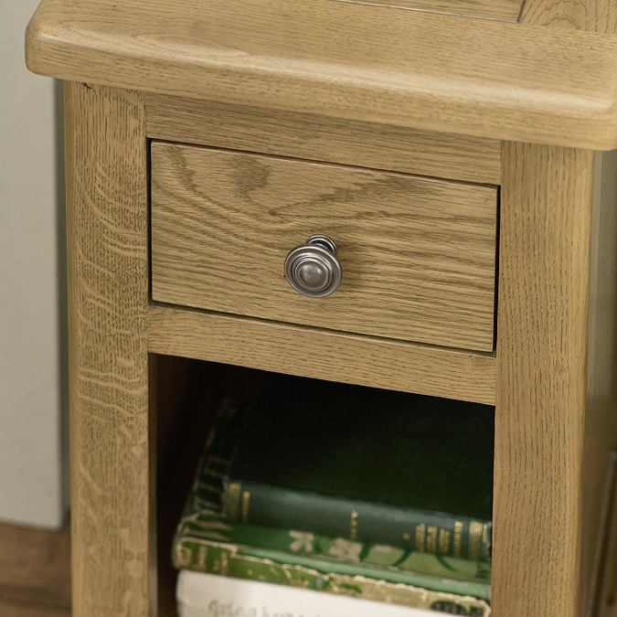 close up image of wooden drawer and round metal knob on bedside table