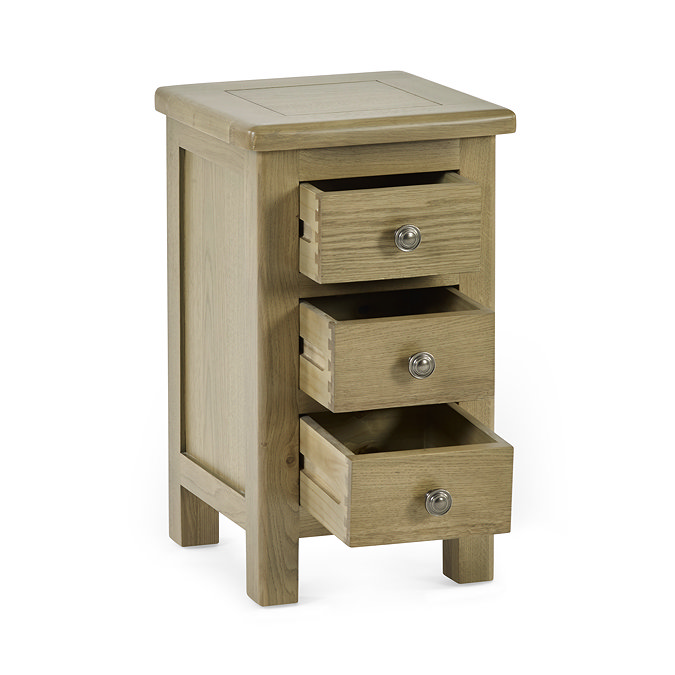 image cut out on white background of slim three drawer bedside table with drawers open