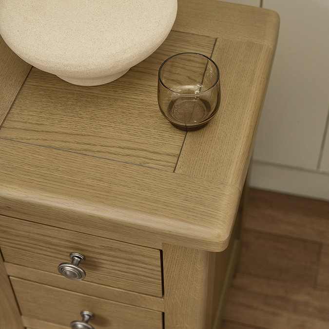 close up image of smooth top of slim oak bedside table