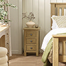 image of slim three drawer bedside table next to matching bed in modern country bedrooms