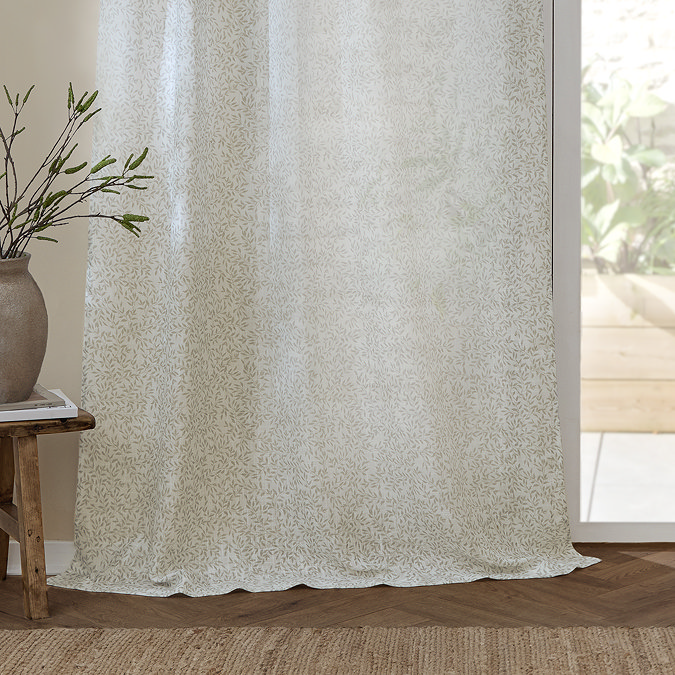 Perrie Leaf Natural Sheer Curtain Panel over a window close up image