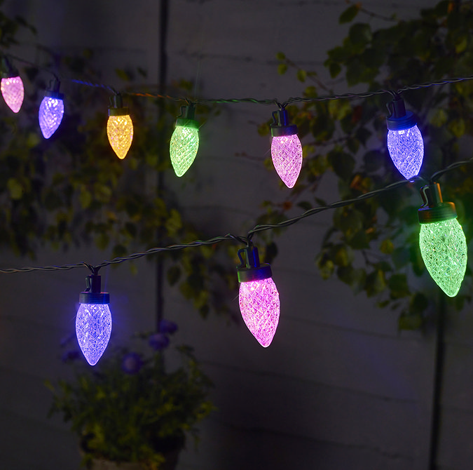 image of pine cone shaped multicoloured string lights glowing at night