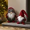 plush grey and red tartan gonk stood next to slightly taller santa gonk with wool hat