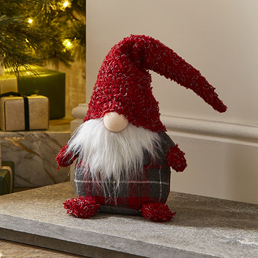 plush grey and red tartan gonk stood next to slightly taller santa gonk with wool hat