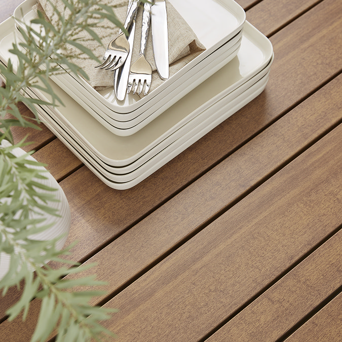 close up image of slatted wood garden dining table