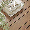close up image of slatted wood garden dining table