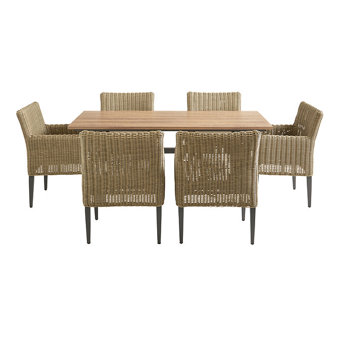 image cut out on white background of rattan dining chairs round slatted wooden dining table