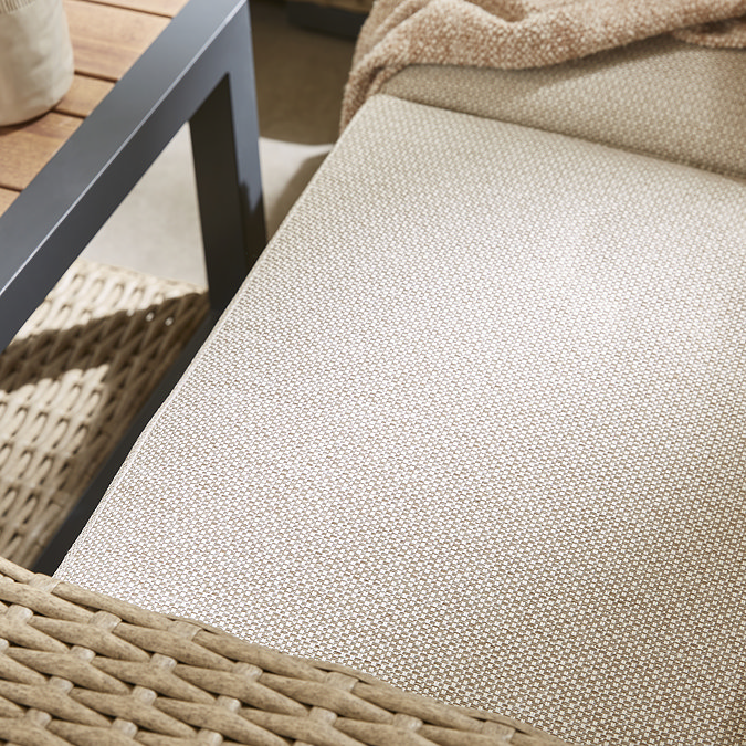 close up image of cream fabric of rattan garden sofa
