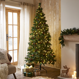 pre-lit cranberry pine tree with warm white LEDs in the middle of a warm living room