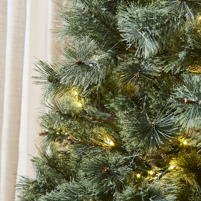 close up image of green artificial branches with warm white LEDs