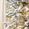 close up on the artificial snowy branches of the spruce tree, with warm white LEDs woven in