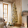 slim white snowy spruce tree, complete with warm white LEDs, in the middle of a warmly lit living room