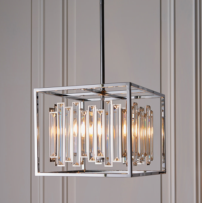 image of cubed chrome frame hanging light with abstract glass shapes hanging in the middle, opaque shaping covering warm lighting diffusing from within