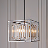 image of cubed chrome frame hanging light with abstract glass shapes hanging in the middle, opaque shaping covering warm lighting diffusing from within