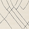 close up swatch image of cream rug with black abstract lines