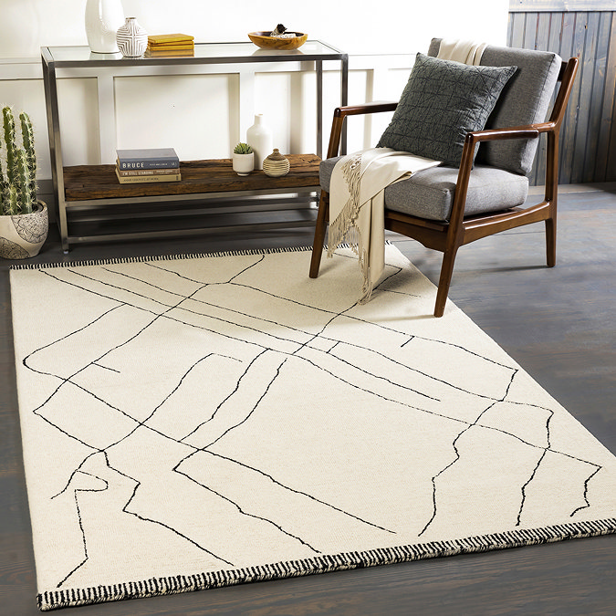 image of cream rug with abstract line design on dark grey flooring