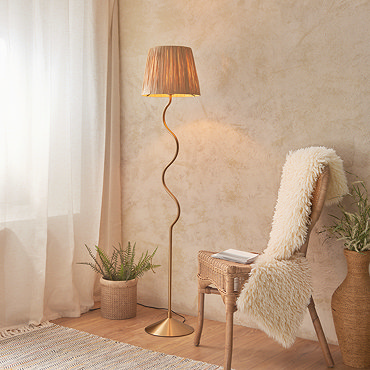 close up on top of lamp with textured shade and wriggle-shaped brass body