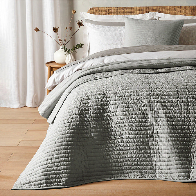 quilted lines bedspread in silver on bed image