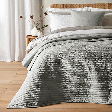 quilted lines bedspread in silver on bed image