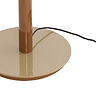 close up image on circular glossy brown base of retro floor lamp, with slim black cable