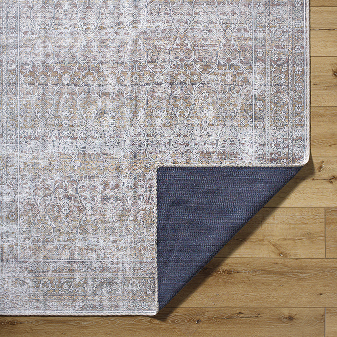 image of corner of boho brown rug folded over at the corner to show material underneath