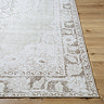 close up image of corner of light sage rug with vintage floral pattern