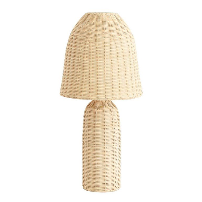 image cut out on white background of natural coloured rattan table lamp with elongated domed shade