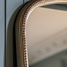 close up image of rounded top of champagne mirror with small bobbling edge detail