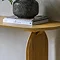 close up on corner of light oak console table with smooth round edge