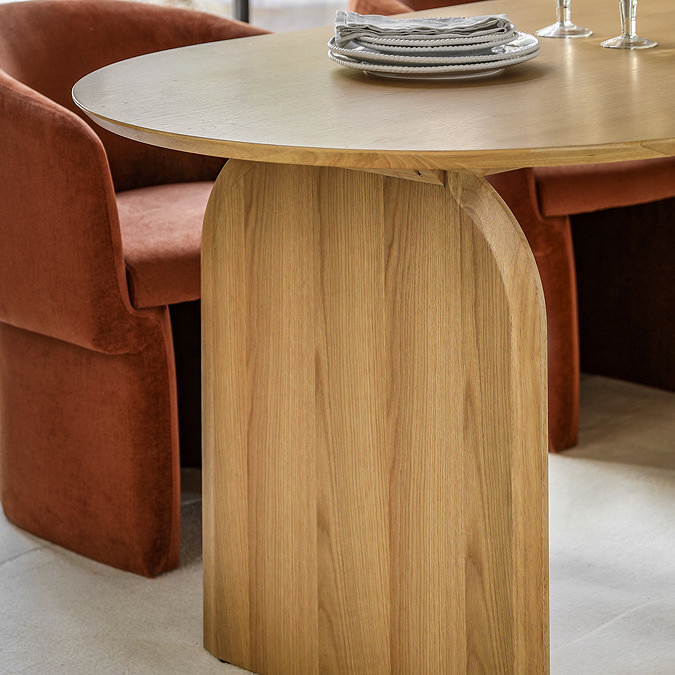 close up on end of curved light oak veneer dining table with smooth edges