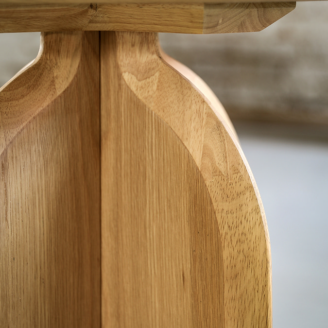 close up on curved leg of light oak side table