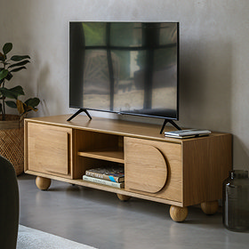 image of light oak veneer tv unit with two drawers and central open shelving, with tv on top.