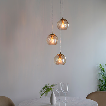 close up image on three dimpled shades of pendant light 
