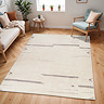 image of cream rug with charcoal line pattern on light wood flooring of modern apartment