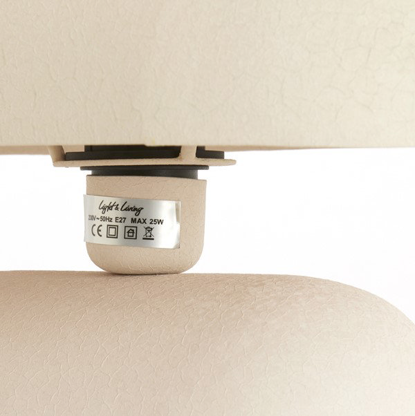 close up image of thin neck of cream table lamp with smooth curved lines