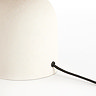 close up image of cream rounded table lamp with black cable