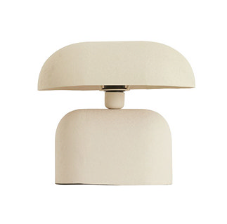 image cut out on white background of cream rounded table lamp with thin domed shade