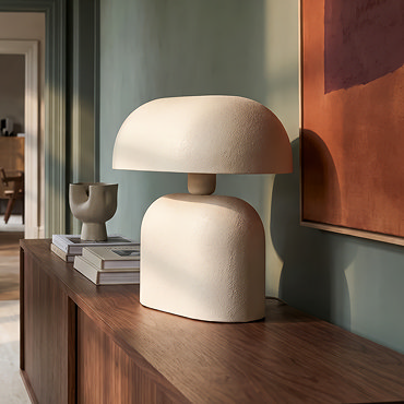 close up image of thin neck of cream table lamp with smooth curved lines
