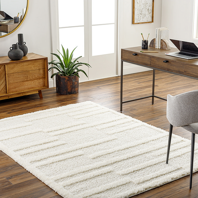 image of super soft cream rectangular rug with tufted geometric lines, on wooden flooring of a home office