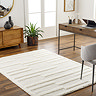 image of super soft cream rectangular rug with tufted geometric lines, on wooden flooring of a home office