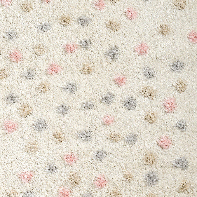 close up zoomed in image of cream super soft rug with multi coloured spots