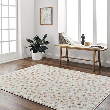 close up image on corner fold of cream and multi coloured dotted rug